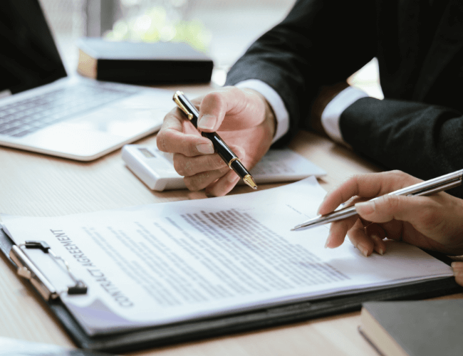 Close-up of male lawyer writing on a clipboard explaining to a client about how to know if you have a personal injury case