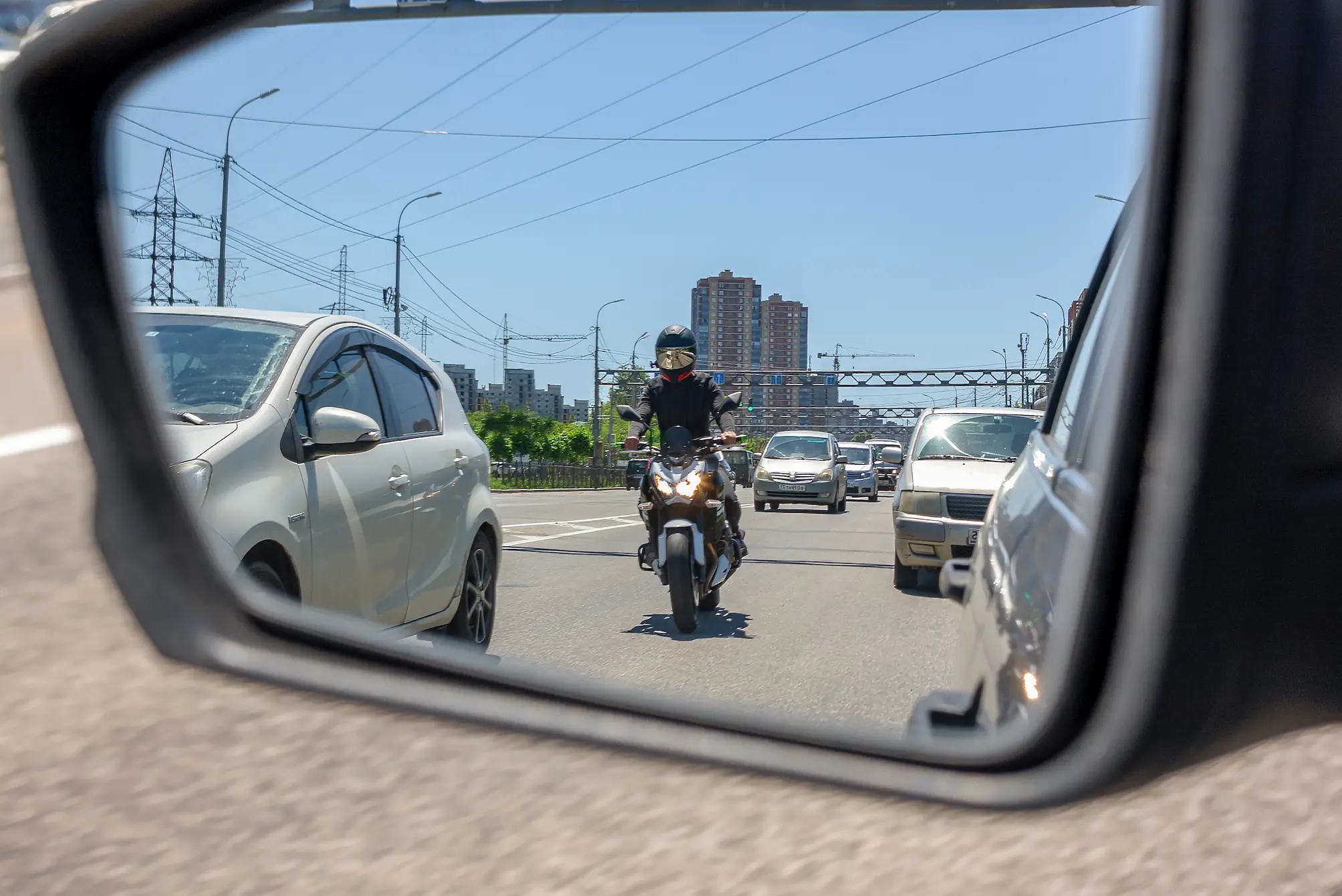 motorcycle accident laws splitting lanes Review-mirror view of biker following motorcycle accident laws by not splitting lanes